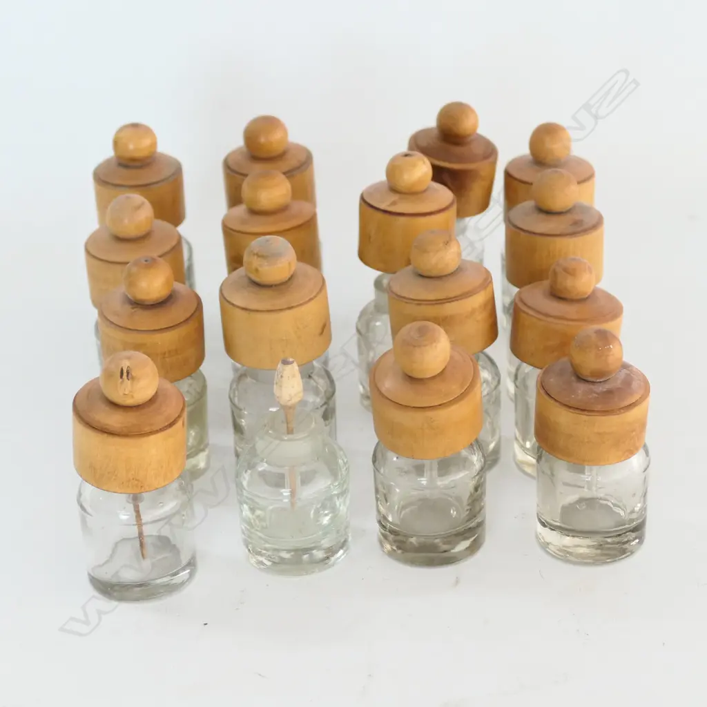 15 SMALL GLASS BOTTLES WITH INSET GROUND GLASS MOUTHS AND TURNED BOXWOOD COVERS Image 1++
